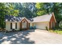 Well-maintained home with an attached two-car garage and a spacious driveway at 2030 Buford Dam Rd, Buford, GA 30518