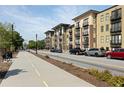 Contemporary apartment complex exterior view with sidewalk and street parking at 5300 Peachtree Rd # 3207, Chamblee, GA 30341