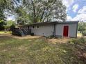 Image of the backyard featuring a wooden deck and a freshly painted exterior at 8236 Tudor Dr, Jonesboro, GA 30238