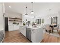 Modern kitchen with an island, stainless steel appliances, open shelving, and hardwood floors at 933 Willingham Dr # 9, Hapeville, GA 30354