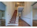 Inviting foyer featuring beautiful hardwood floors, an elegant staircase, and traditional design elements at 1216 Valley Dr, Conyers, GA 30012