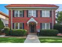 Charming brick home featuring a red tile roof, black shutters and mature landscaping at 824 Greenwood Ne Ave # 8, Atlanta, GA 30306