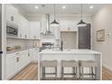 Well-lit kitchen boasts white cabinets, stainless steel appliances, a center island, and bar stool seating at 931 Willingham Dr # 10, Hapeville, GA 30354