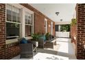 Inviting front porch featuring comfortable seating, brick columns, and stylish outdoor decor at 19 Wyman Se St, Atlanta, GA 30317