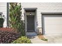 Front door with dark trim and a single car garage on a townhome at 6345 Mountain Home Se Way, Mableton, GA 30126
