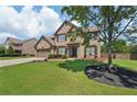 Charming two-story brick home with a well-manicured lawn and attached two car garage at 852 Van Briggle Path, Sugar Hill, GA 30518