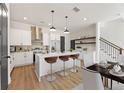 Bright kitchen with white cabinets, island with seating, and stainless steel appliances at 927 Willingham Dr # 12, Hapeville, GA 30354