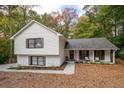 Charming split-level home with white painted brick, tidy landscaping, and a cozy front porch with rocking chairs at 2377 Emory Ln, Marietta, GA 30068