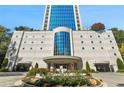Stately condo entrance featuring modern architecture, a landscaped circular driveway and covered parking access at 2828 Peachtree Nw Rd # 1502, Atlanta, GA 30305