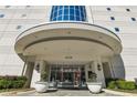 Well lit condo building entrance featuring manicured landscaping and an elegant covered entryway at 2828 Peachtree Nw Rd # 1502, Atlanta, GA 30305
