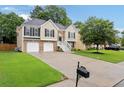 Inviting two-story home with a well-manicured lawn and a spacious driveway leading to a two-car garage at 4040 Brightmore Dr, Austell, GA 30106