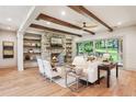 Inviting living room with exposed beams, stone fireplace, and seamless indoor-outdoor flow at 298 Saint Marys Nw Ln, Marietta, GA 30064
