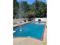 Refreshing pool area with lounge chairs and a white fence, perfect for relaxation and outdoor enjoyment at 1417 Doe Valley Dr, Lithonia, GA 30058