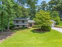 Well-maintained home featuring a lush green lawn and mature trees in a serene setting at 579 Chapman Dr, Marietta, GA 30066