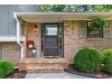 Inviting front entrance with brick steps, decorative plants, and detailed door at 579 Chapman Dr, Marietta, GA 30066