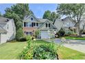 Charming home with well-kept lawn and garden, with blooming lilies in the front yard at 335 Pintail Ct, Suwanee, GA 30024