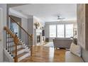 Open-concept living room with hardwood floors, fireplace, and abundant natural light at 4765 Silver Leaf Dr, Cumming, GA 30040