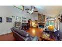 Spacious living room with vaulted ceilings, wood floors, stone fireplace, and abundant natural light at 4915 Millers Trce, Peachtree Corners, GA 30096