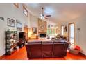 Spacious living room with stone fireplace, vaulted ceilings, hardwood floors, and natural light at 4915 Millers Trce, Peachtree Corners, GA 30096
