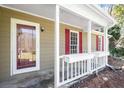 Cozy front porch with red shutters, white railings, and flower boxes at 500 Rosehill Dr, Mcdonough, GA 30253