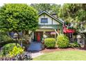 Charming home with lush front yard, mature trees, inviting porch, and colorful flower beds enhancing curb appeal at 966 Blue Ridge Ne Ave, Atlanta, GA 30306