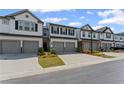 Exterior shot of well-maintained townhomes with driveways at 3560 Bexton Dr, Duluth, GA 30097