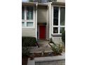 Exterior facade featuring a vibrant red door and large windows bringing in natural light at 1932 Variations Ne Dr, Atlanta, GA 30329