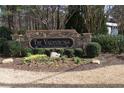 Community entrance sign with stone base surrounded by manicured shrubs and greenery at 1932 Variations Ne Dr, Atlanta, GA 30329