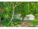 Quaint single-Gathering home featuring a manicured lawn and traditional architectural details at 230 Belmont Trl, Covington, GA 30016