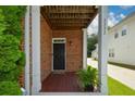 Inviting covered porch with brick facade and a dark front door at 3332 Chastain Landings Ct, Marietta, GA 30066