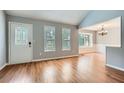 Bright living room featuring hardwood floors, a decorative front door, and ample natural light at 5093 Ravenwood Dr, Marietta, GA 30066