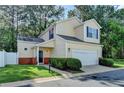 Charming two-story home with a two-car garage and well-maintained front lawn at 609 Bedford Court, Woodstock, GA 30188