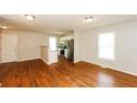 Open-concept living space showcasing hardwood floors and modern kitchen with stainless steel appliances at 1112 Smith St, Atlanta, GA 30310