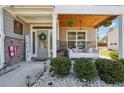 Inviting front porch with a swing, stone accents, and a charming, decorative entrance at 2860 Windsor Knoll Dr, Dacula, GA 30019