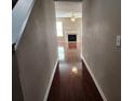 Inviting hallway featuring beautiful wood floors leading to a cozy living room with fireplace at 378 Durmire Dr, Jonesboro, GA 30236