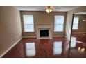 Bright living room featuring hardwood floors, a fireplace, and large windows with natural light at 378 Durmire Dr, Jonesboro, GA 30236