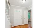 Welcoming foyer with hardwood floors, staircase, and neutral paint at 658 Slew Ave, Lawrenceville, GA 30043