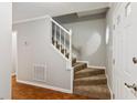 Carpeted staircase with white railing and neutral walls at 658 Slew Ave, Lawrenceville, GA 30043