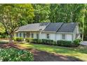 Beautiful single-story home with green lawn, tasteful landscaping, and an attached carport at 1590 Sunnybrook Farm Rd, Atlanta, GA 30350