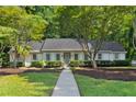 Lovely single-story home with a well-maintained lawn, mature trees, and inviting walkway at 1590 Sunnybrook Farm Rd, Atlanta, GA 30350