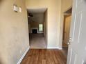 Inviting entryway with hardwood floors, leading to the living room with a cozy fireplace at 535 Village Cir, Stockbridge, GA 30281