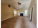 Spacious living room featuring a fireplace, carpet and a ceiling fan at 535 Village Cir, Stockbridge, GA 30281