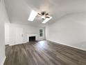 Spacious living room featuring high ceilings, skylights, and a cozy fireplace at 7972 Woodlake Dr, Riverdale, GA 30274