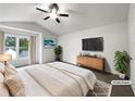 Bright main bedroom featuring vaulted ceilings, a ceiling fan, and ample natural light at 7972 Woodlake Dr, Riverdale, GA 30274