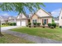 Attractive home with a manicured lawn, stone accents, and a two-car garage in a friendly neighborhood at 918 Harvest Brook Dr, Lawrenceville, GA 30043