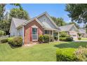 A charming one-story home with brick accents and a lush green lawn at 1875 Conners Ct, Lawrenceville, GA 30044