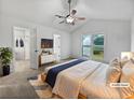 Bright bedroom featuring carpet, large windows, vaulted ceiling, and an ensuite bathroom at 5021 Rodrick Trce, Marietta, GA 30066