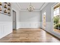 Formal dining room featuring natural light, gray walls, white trim, and hardwood floors at 507 Mirramont Pl, Woodstock, GA 30189