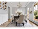 Dining room with a coffered ceiling, hardwood floors, windows, gray walls, and white trim at 507 Mirramont Pl, Woodstock, GA 30189
