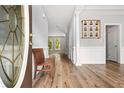 Bright foyer with hardwood floors, neutral paint, white trim, and a traditional wooden bench at 507 Mirramont Pl, Woodstock, GA 30189
